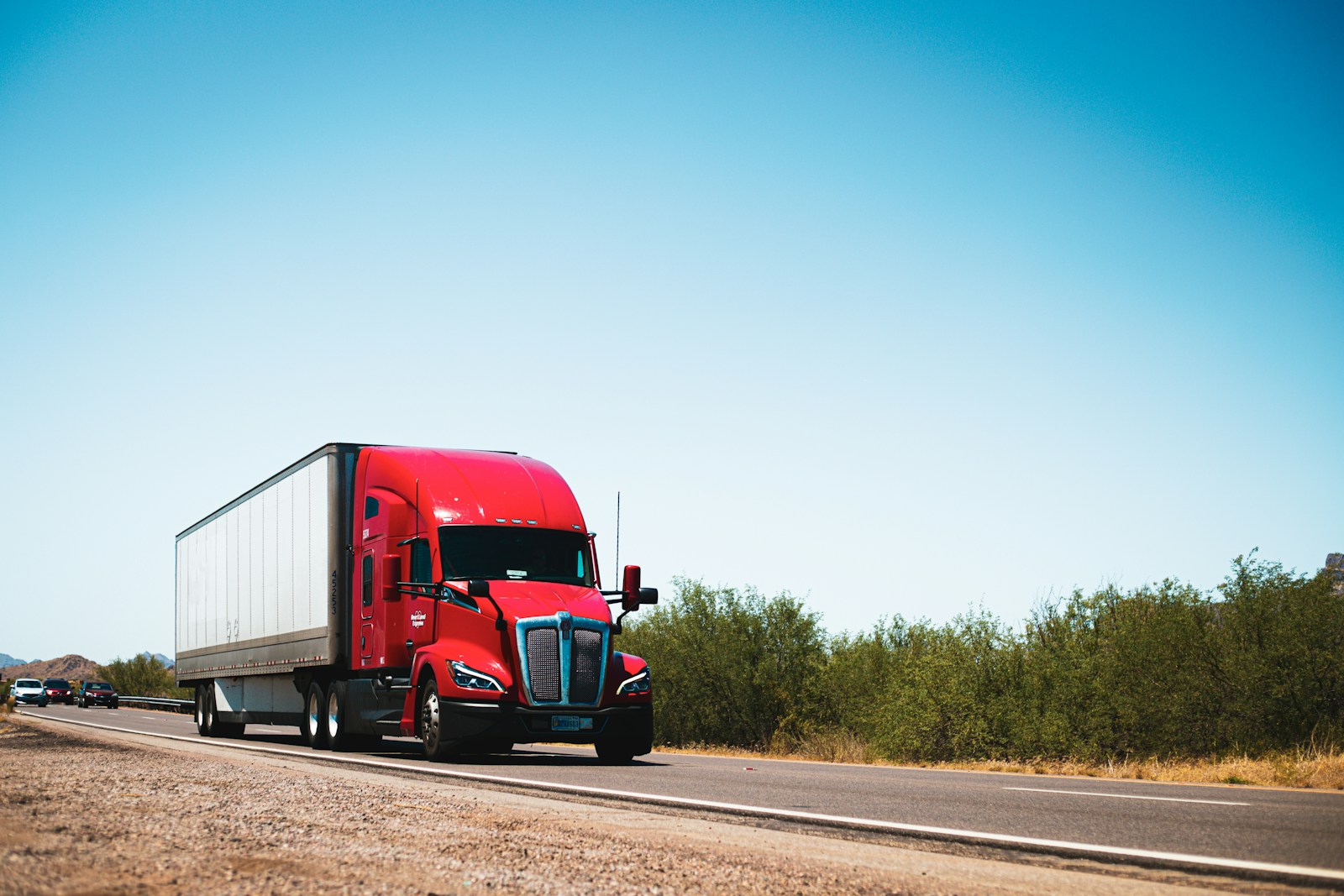 Semi truck hauling a freight trailer along an open road